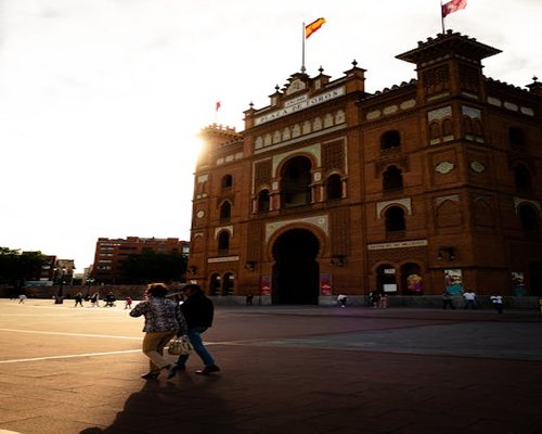 Woman taking a relaxing walk in a Spanish city plaza during warm sunset